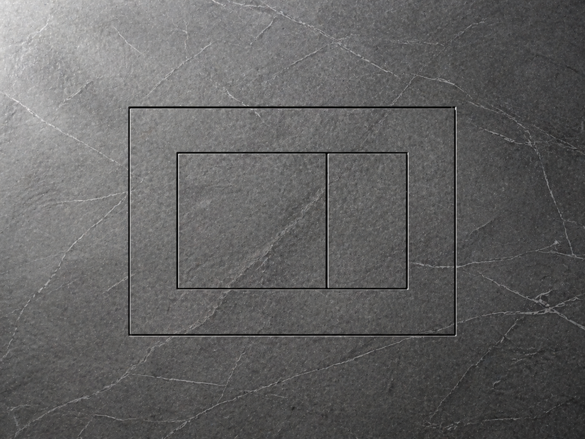 The flush plate outline etched into dramatic dark slate stone