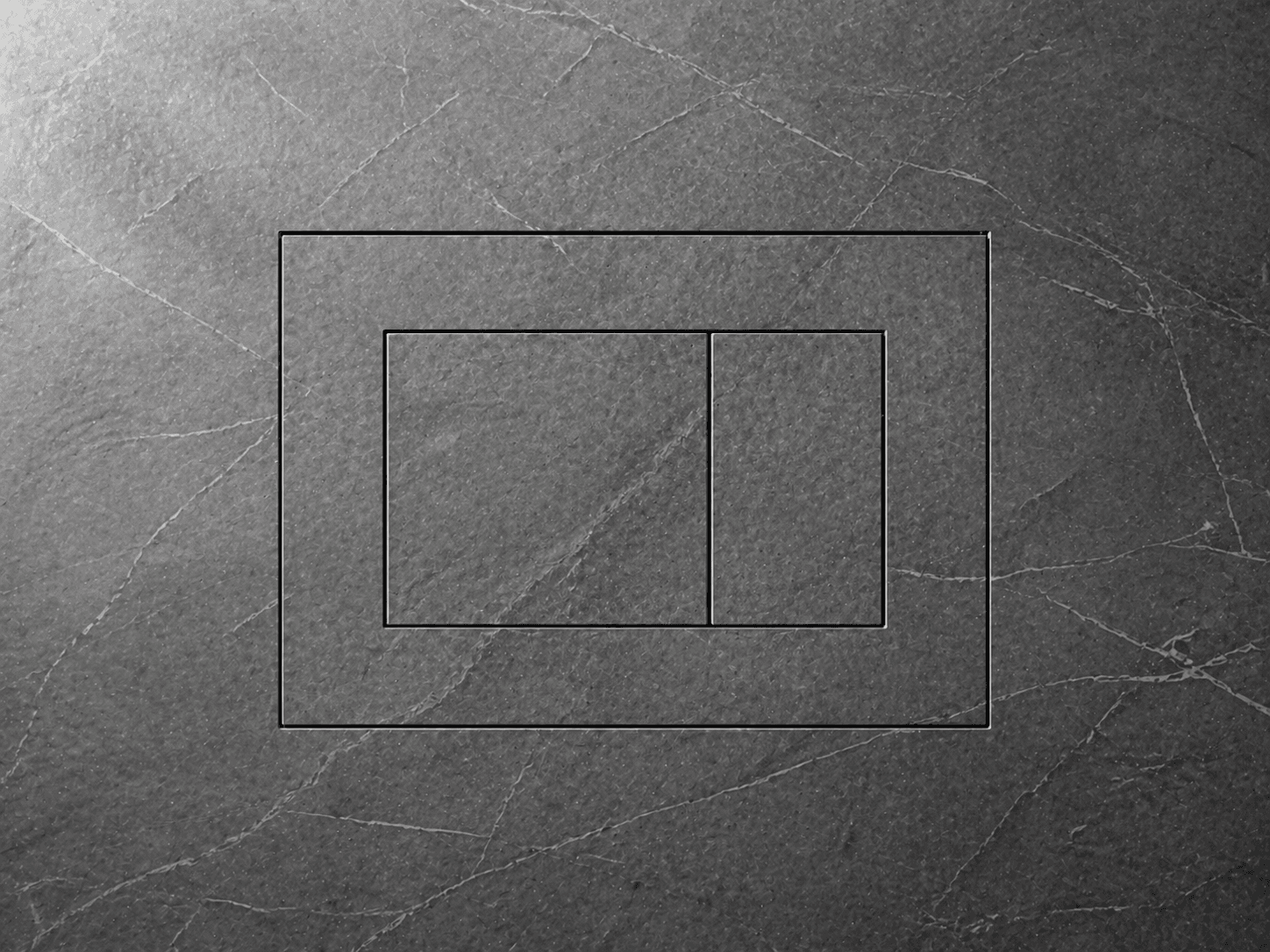 The flush plate outline etched into dramatic dark slate stone
