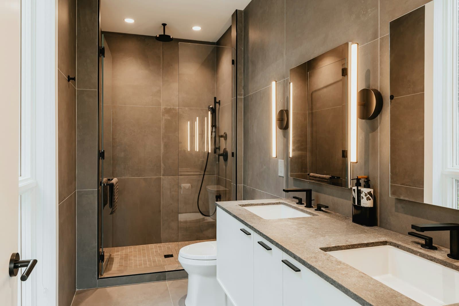 Walk-in glass shower with warm wood and stone