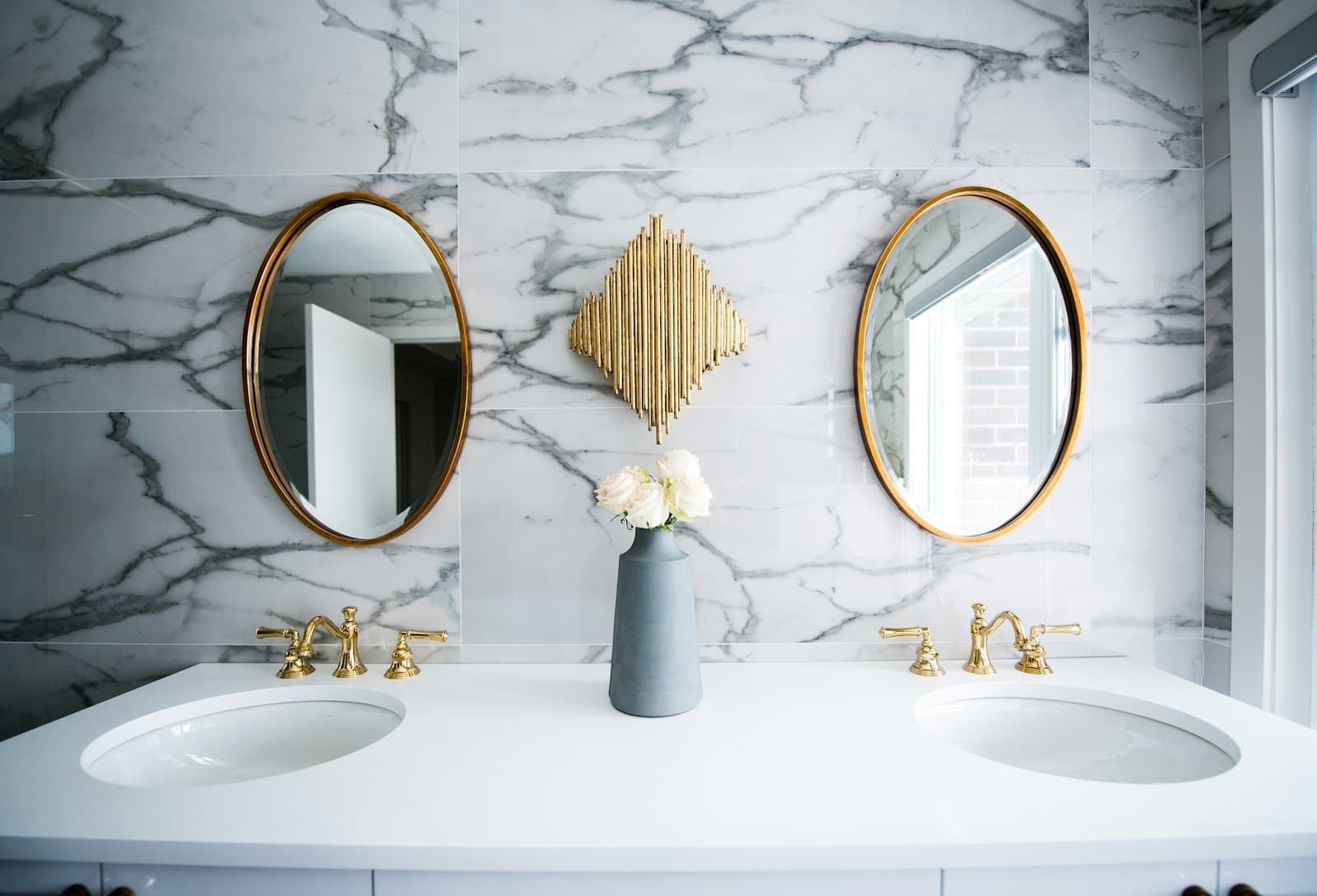 Marble bathroom with twin round mirrors