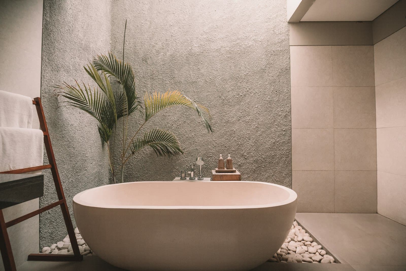 Freestanding tub in a warm stone bathroom